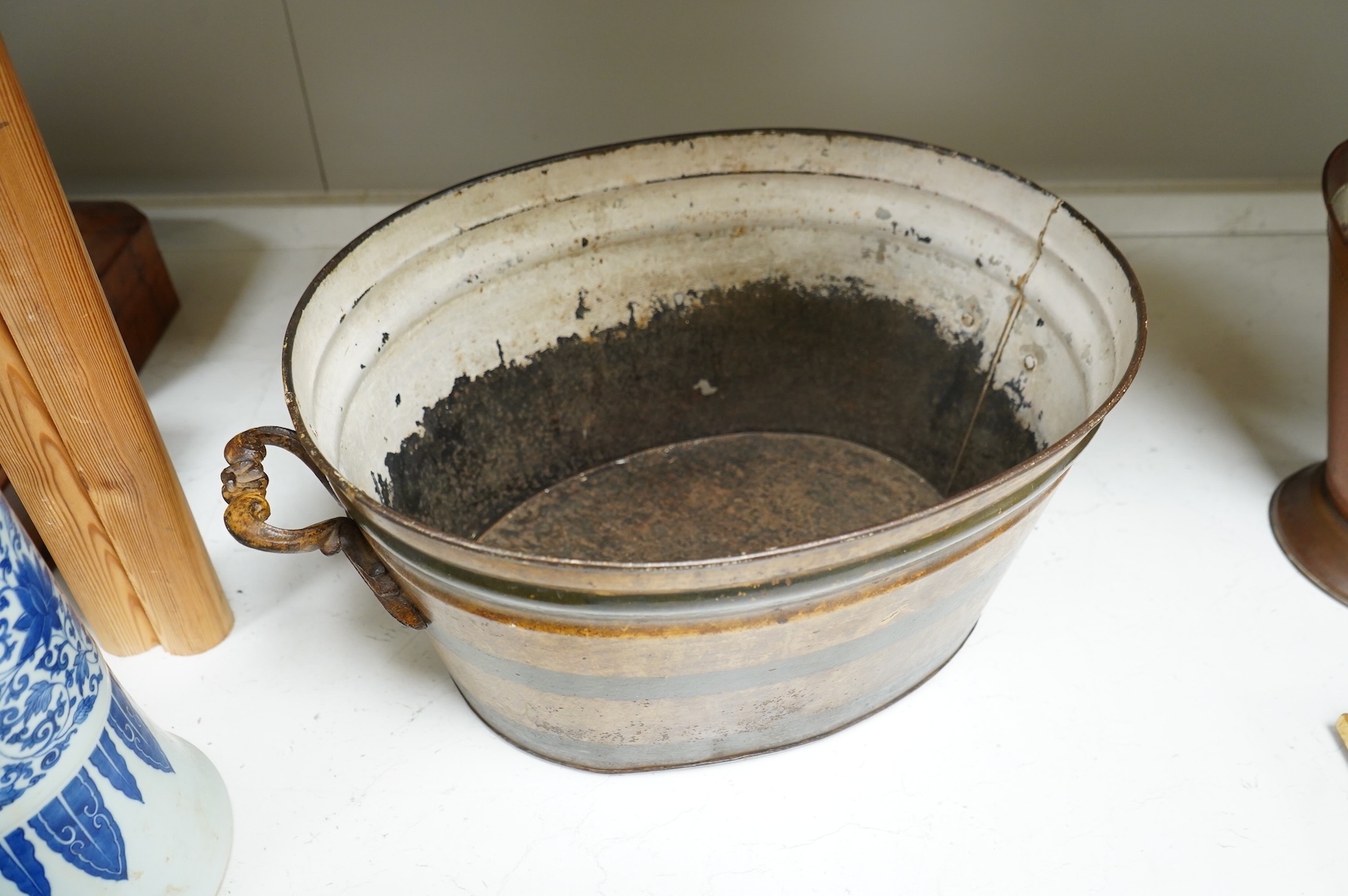 An oval toleware bin and another similar smaller bucket with swing handle, 48cm wide
